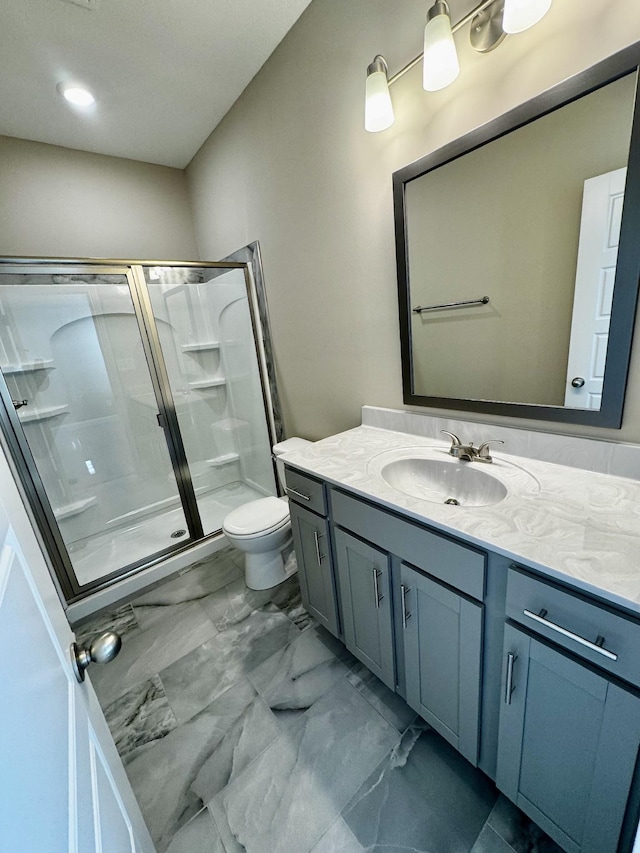 bathroom with an enclosed shower, vanity, and toilet