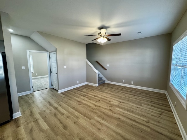 unfurnished living room featuring ceiling fan and light hardwood / wood-style flooring