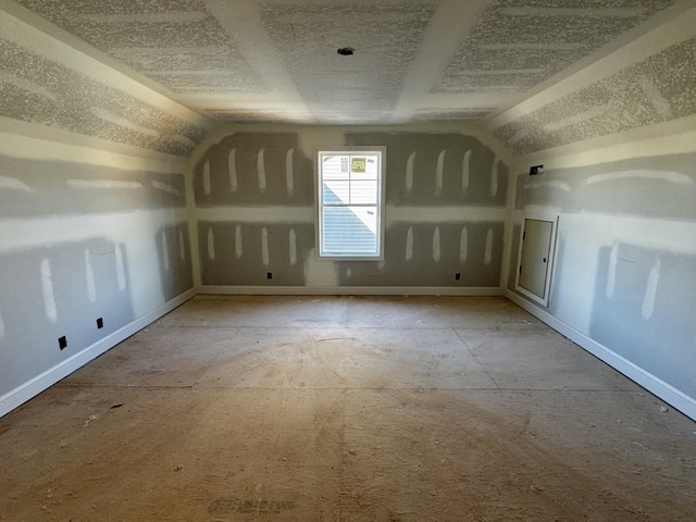 additional living space featuring lofted ceiling