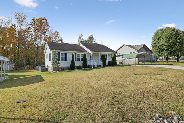 ranch-style home featuring covered porch, a carport, and a front yard