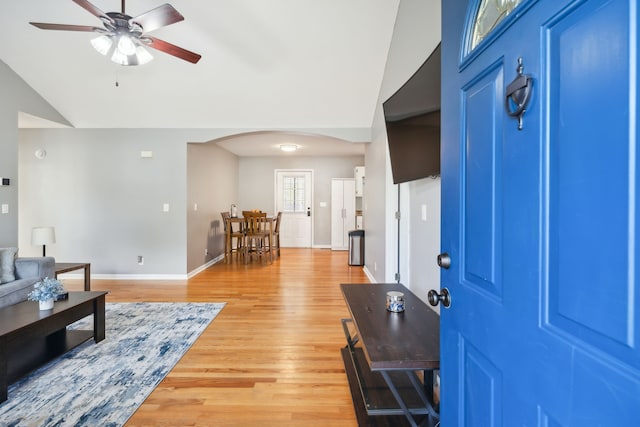 entrance foyer featuring light hardwood / wood-style floors, ceiling fan, and vaulted ceiling