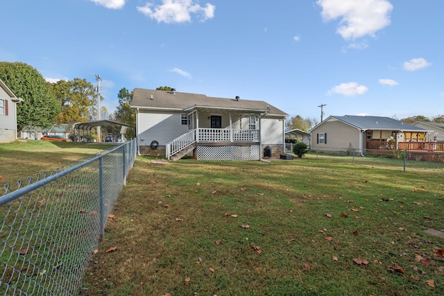 back of property featuring a yard and covered porch