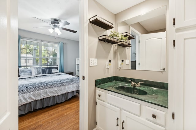 bathroom with vanity, hardwood / wood-style floors, and ceiling fan