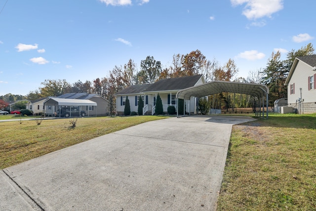 ranch-style home featuring a front yard and a carport