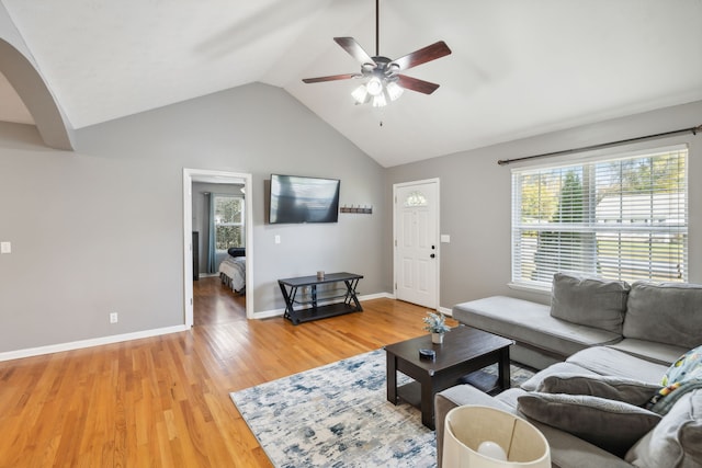 living room featuring ceiling fan, hardwood / wood-style flooring, and vaulted ceiling