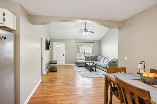 interior space with ceiling fan, lofted ceiling, and light wood-type flooring