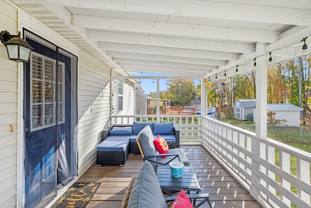 deck with a storage unit and an outdoor living space