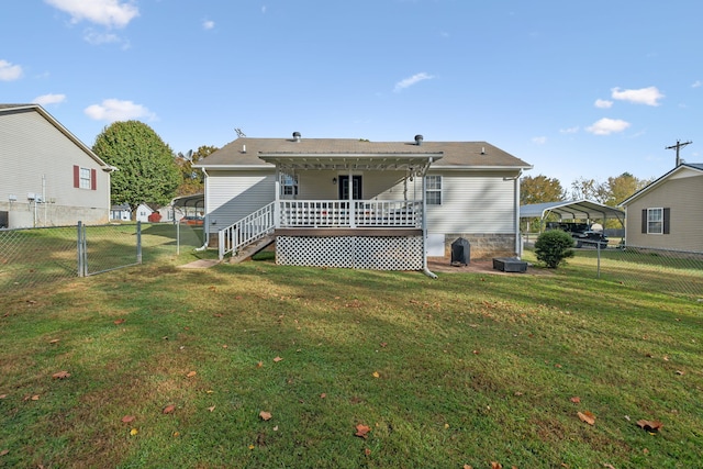 rear view of house featuring a wooden deck and a yard