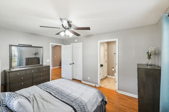 bedroom featuring ceiling fan, ensuite bathroom, and light hardwood / wood-style floors