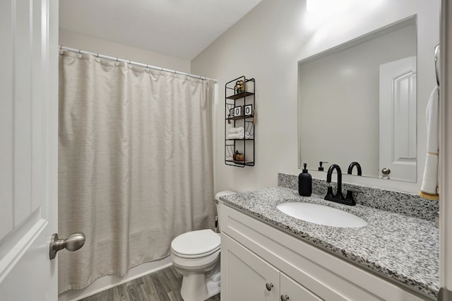 bathroom featuring vanity, hardwood / wood-style floors, curtained shower, and toilet