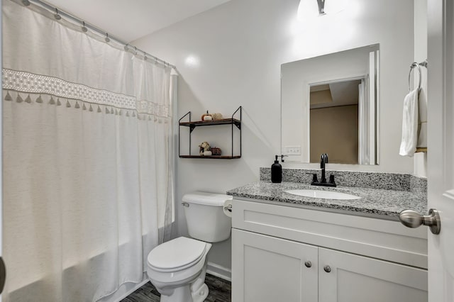 full bathroom featuring vanity, hardwood / wood-style floors, toilet, and shower / tub combo