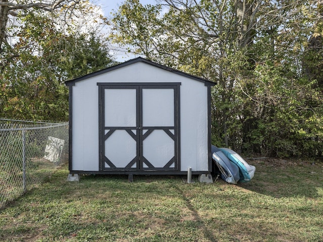 view of outdoor structure featuring a lawn