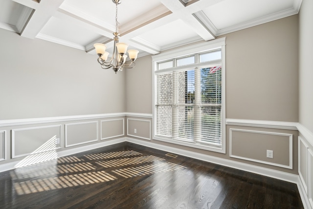 spare room with ornamental molding, dark wood-type flooring, a chandelier, and coffered ceiling