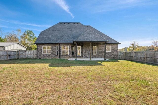 back of property featuring a lawn and a patio area