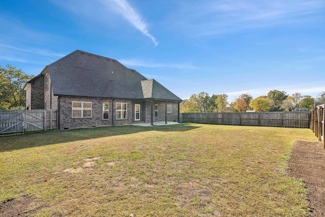 back of property featuring a lawn and a patio