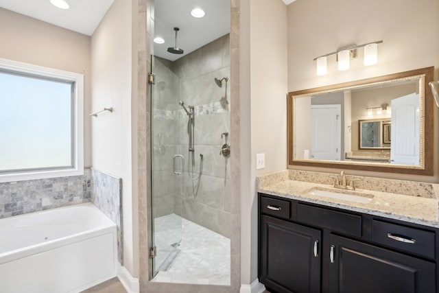 bathroom with vanity and separate shower and tub