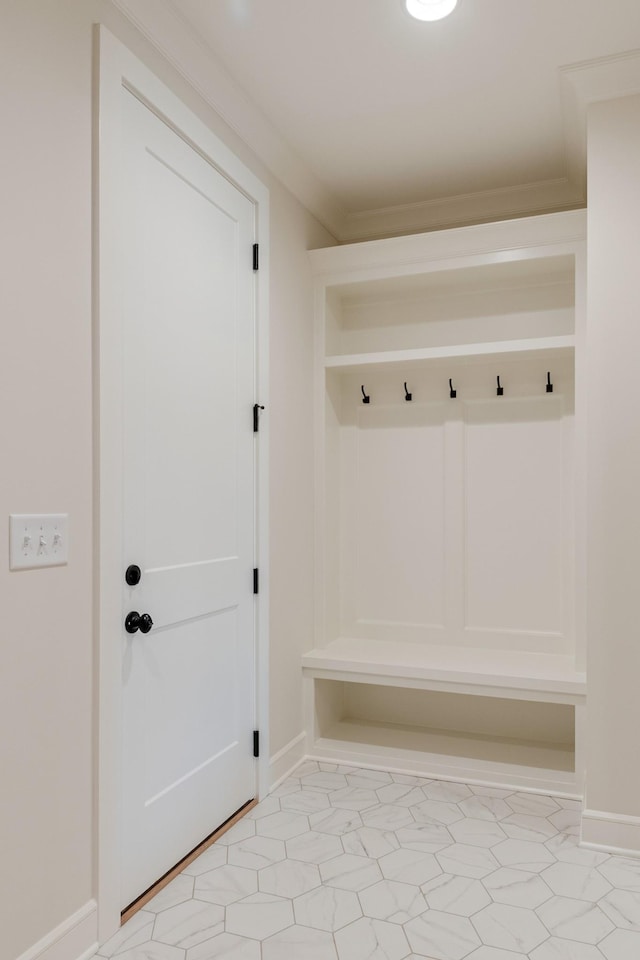mudroom with crown molding and baseboards