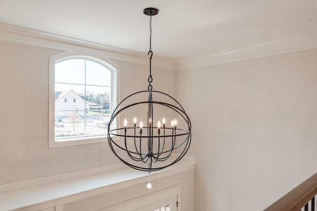 interior details featuring ornamental molding and a chandelier