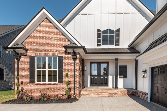 property entrance featuring covered porch and a garage