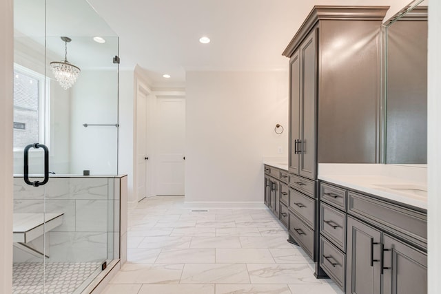 full bathroom featuring recessed lighting, double vanity, marble finish floor, and an inviting chandelier