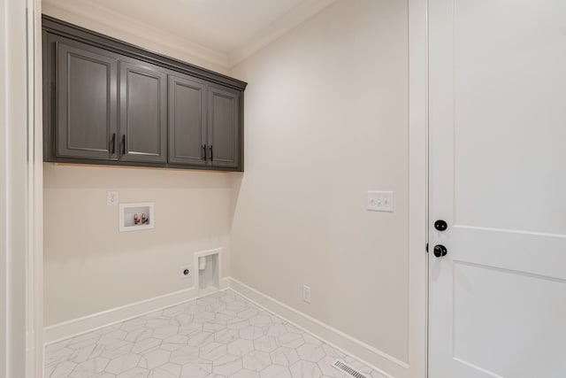 clothes washing area featuring cabinets, washer hookup, light tile patterned floors, ornamental molding, and electric dryer hookup