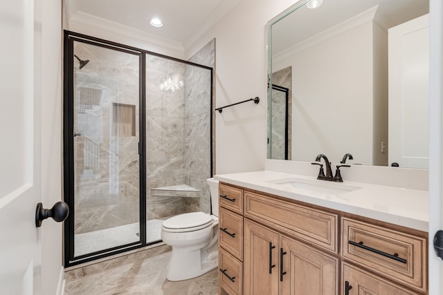 bathroom with toilet, crown molding, vanity, and a shower with door