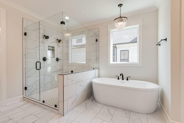 full bath featuring marble finish floor, a freestanding bath, a stall shower, and a notable chandelier