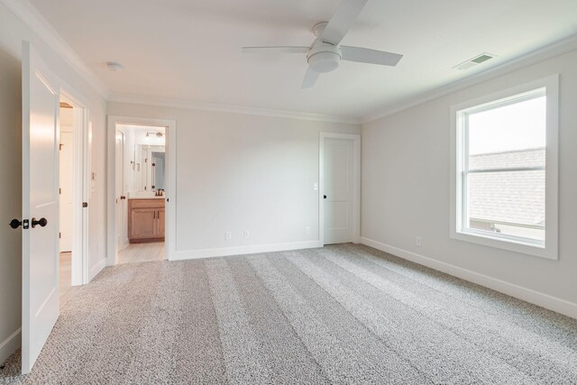 unfurnished bedroom with crown molding, baseboards, visible vents, and light carpet