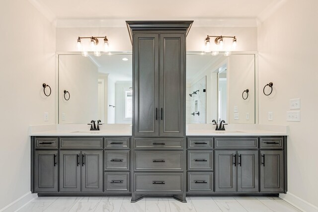 full bathroom with double vanity, a sink, and marble finish floor