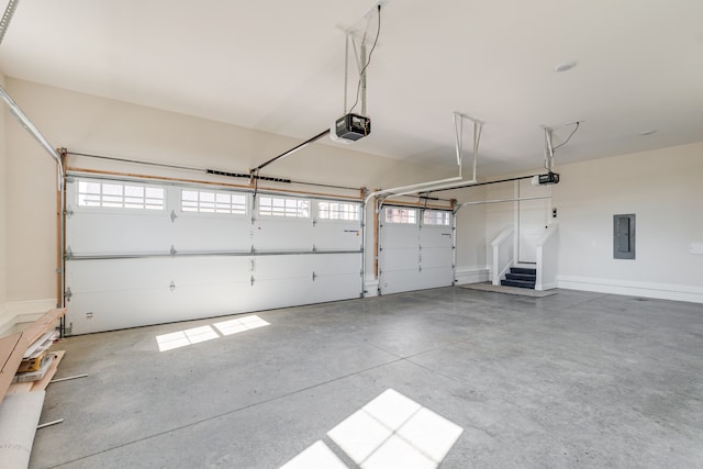 garage with a garage door opener and electric panel