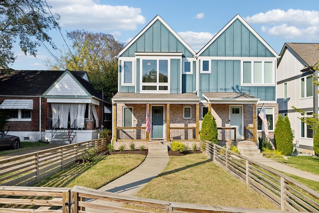 view of front facade with a front yard and a porch