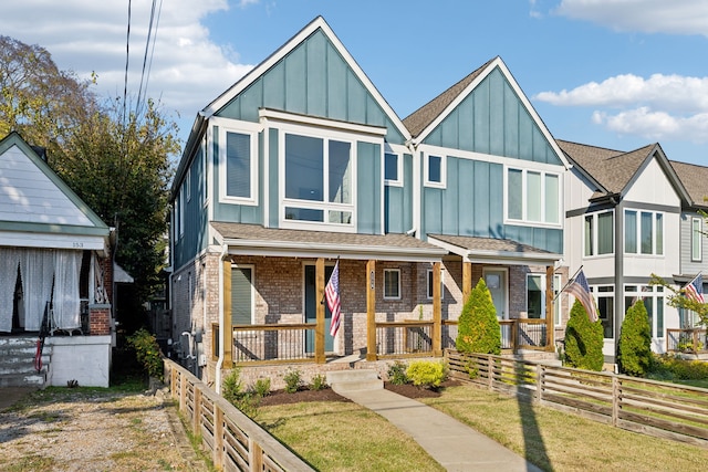 view of front of home with a front yard and a porch