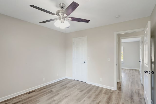 empty room featuring ceiling fan and light wood-type flooring