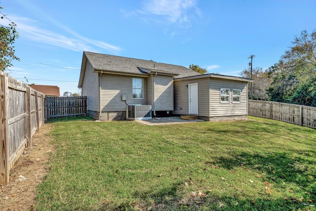 back of property with central AC, a yard, and a patio