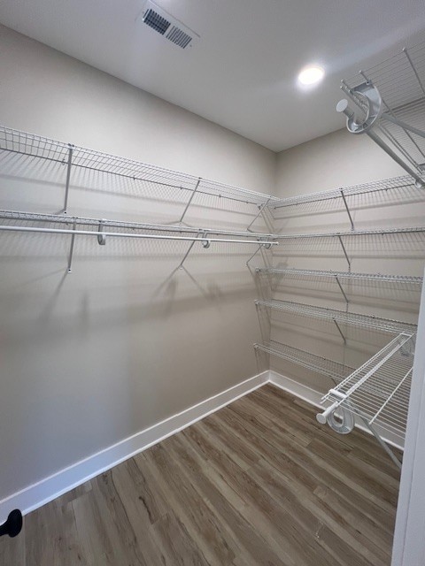 spacious closet featuring hardwood / wood-style flooring