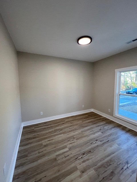 unfurnished room featuring hardwood / wood-style flooring