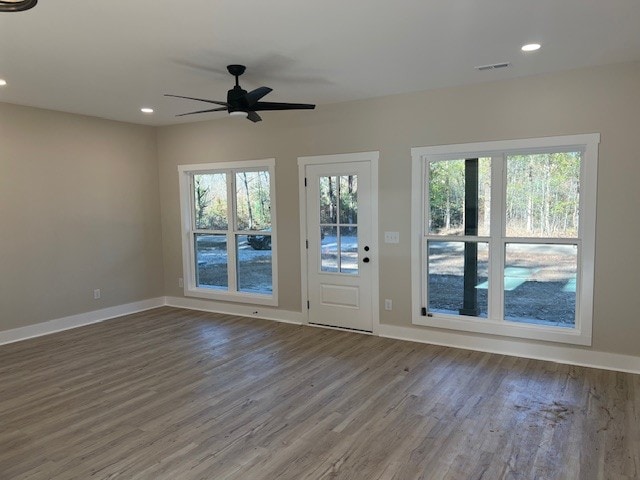 unfurnished room with hardwood / wood-style flooring and ceiling fan