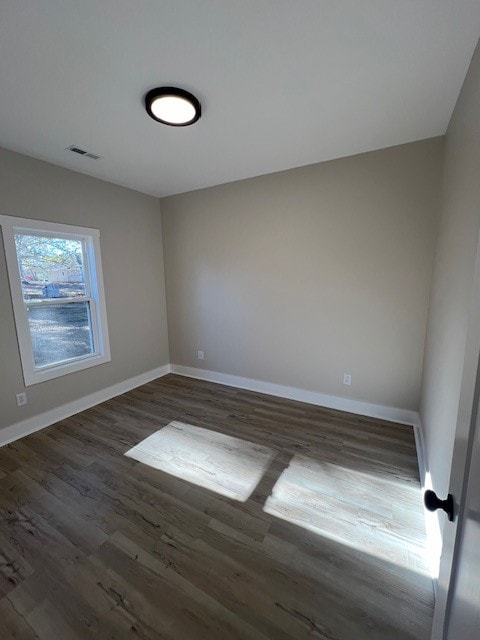 unfurnished room featuring dark hardwood / wood-style flooring