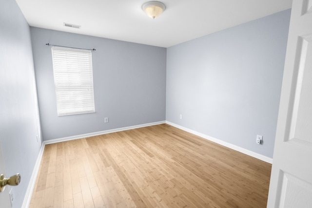 unfurnished room with hardwood / wood-style flooring