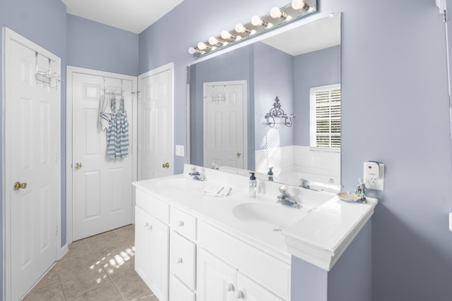 bathroom with vanity, tile patterned flooring, and a bathing tub