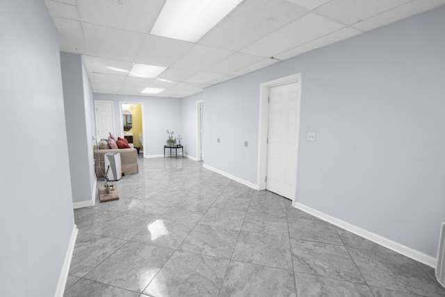 basement with a paneled ceiling