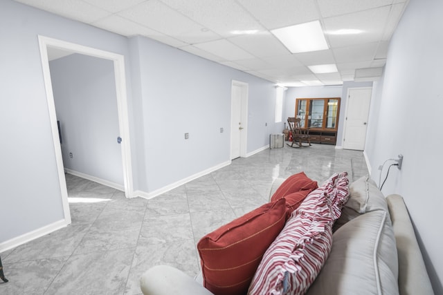 living room featuring a paneled ceiling