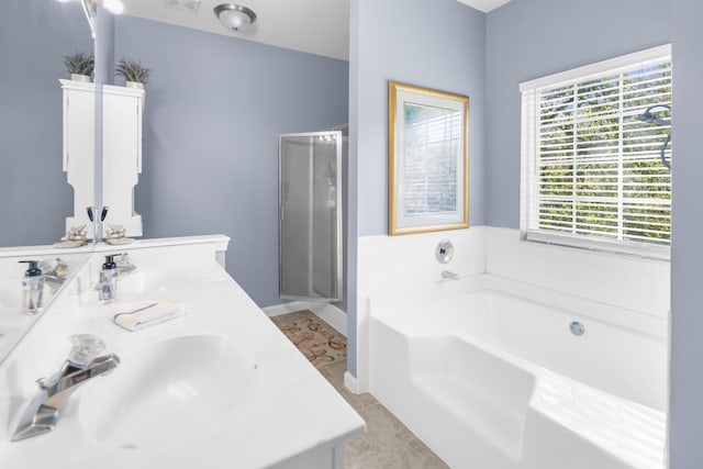 bathroom featuring vanity, shower with separate bathtub, and tile patterned floors