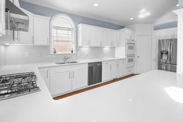 kitchen with backsplash, appliances with stainless steel finishes, and white cabinets