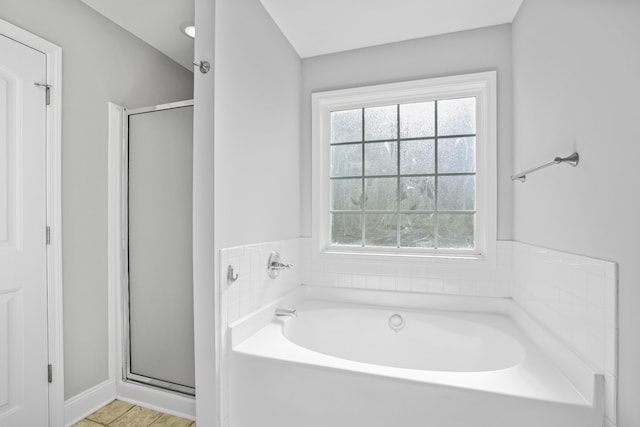 bathroom featuring separate shower and tub and tile patterned floors