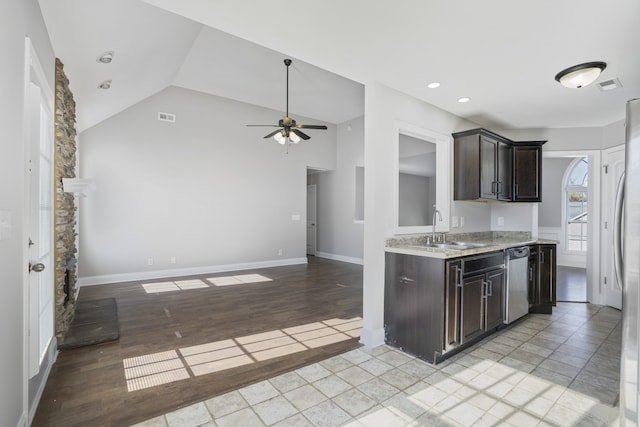 kitchen featuring lofted ceiling, light hardwood / wood-style flooring, sink, stainless steel dishwasher, and ceiling fan