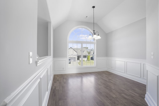 unfurnished dining area with lofted ceiling, a notable chandelier, and dark hardwood / wood-style floors