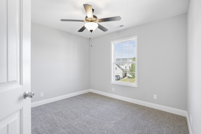 carpeted spare room with ceiling fan