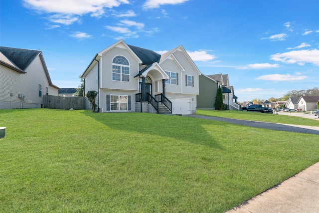 bi-level home featuring a front lawn and a garage