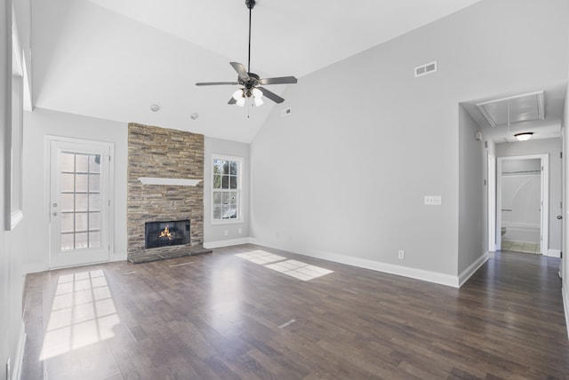 unfurnished living room with dark wood-type flooring, ceiling fan, high vaulted ceiling, and a fireplace